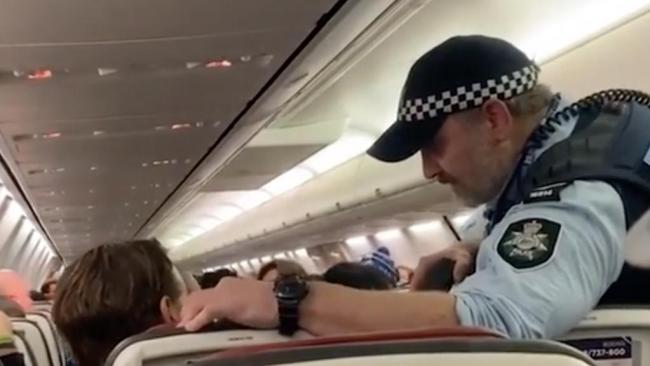 Wild moment cop threatens to taser Virgin passenger before arresting him