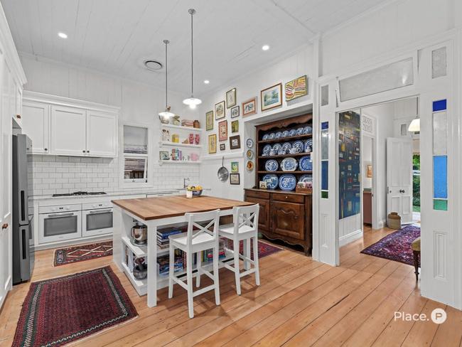 The kitchen at 20 Faversham Street, Woolloongabba contains European appliances and Carrara marble countertops with an American oak kitchen island.