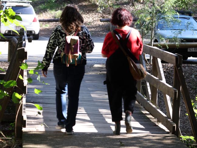 Two female walkers return to their car after hear about the  attempted sexual assault on the Cockatoo Trail, Mt Coot-Tha. Picture: Liam Kidston