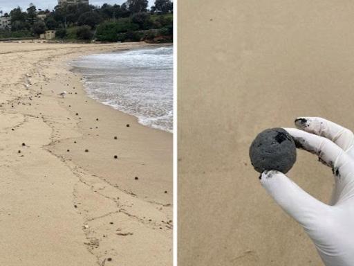 Mysterious black balls have washed up on Sydney's Coogee Beach. Picture: 9News