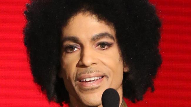 FILE - In this Nov. 22, 2015 file photo, Prince presents the award for favorite album - soul/R&B at the American Music Awards in Los Angeles. Prince, widely acclaimed as one of the most inventive and influential musicians of his era with hits including "Little Red Corvette," ''Let's Go Crazy" and "When Doves Cry," was found dead at his home on Thursday, April 21, 2016, in suburban Minneapolis, according to his publicist. He was 57. (Photo by Matt Sayles/Invision/AP, File)