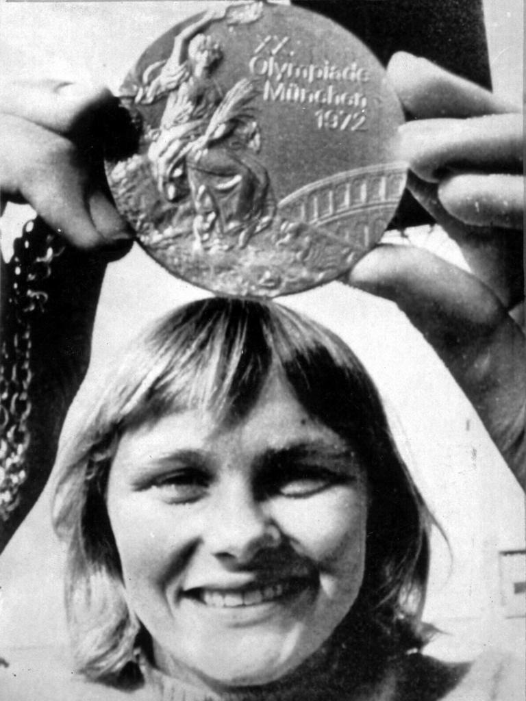 Aust swimmer Shane Gould holding up gold medal won at 1972 Munich Olympic Games. p/