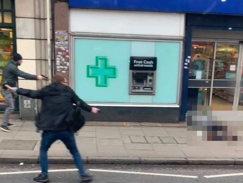 Police aim their guns at the man suspected of stabbing three people on a busy London street in a “terrorist related” incident. Picture: Supplied