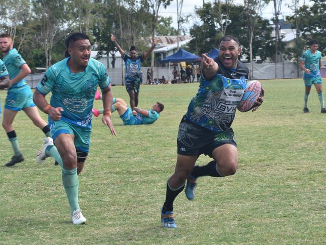 Javarn White celebrates as he prepares to go in for a try for Tunuba Dakani in the men's grand final at the Warba Wangarunya Rugby League Carnival.