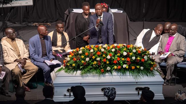 Friends and loved ones gather beside Mr Arow’s coffin. Picture: Jay Town