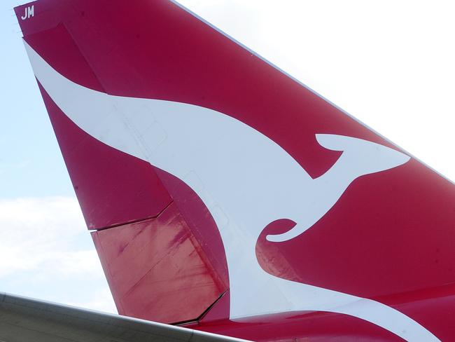 L to R: Qantas Aircraft Maintainence engineer Tim Hogan, member for Kingsford -Smith Matt Thistlethwaite and Maintainence Assistant Peter Freudenreich on the Tarmac at the Qantas Jet base. Many Qantas works face the axe.  Picture: John Appleyard