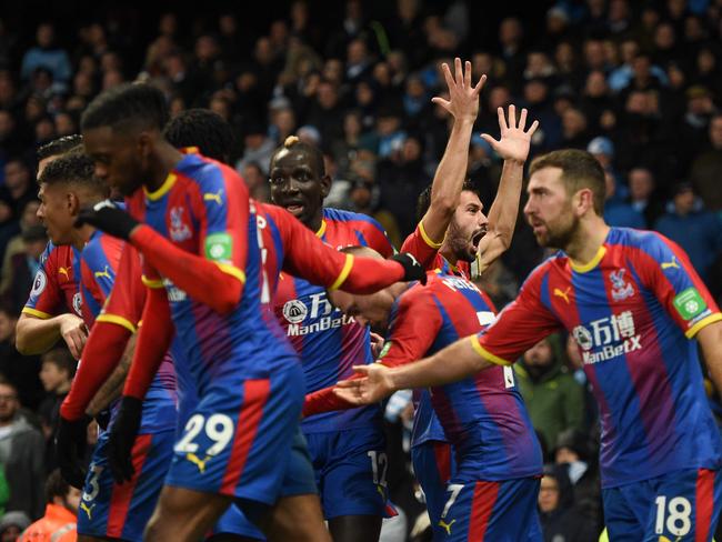 Crystal Palace's Serbian midfielder Luka Milivojevic (C) celebrates scoring their third goal from the penalty spot to extend their lead 1-3 during the English Premier League football match between Manchester City and Crystal Palace. Picture: Oli Scarff/AFP