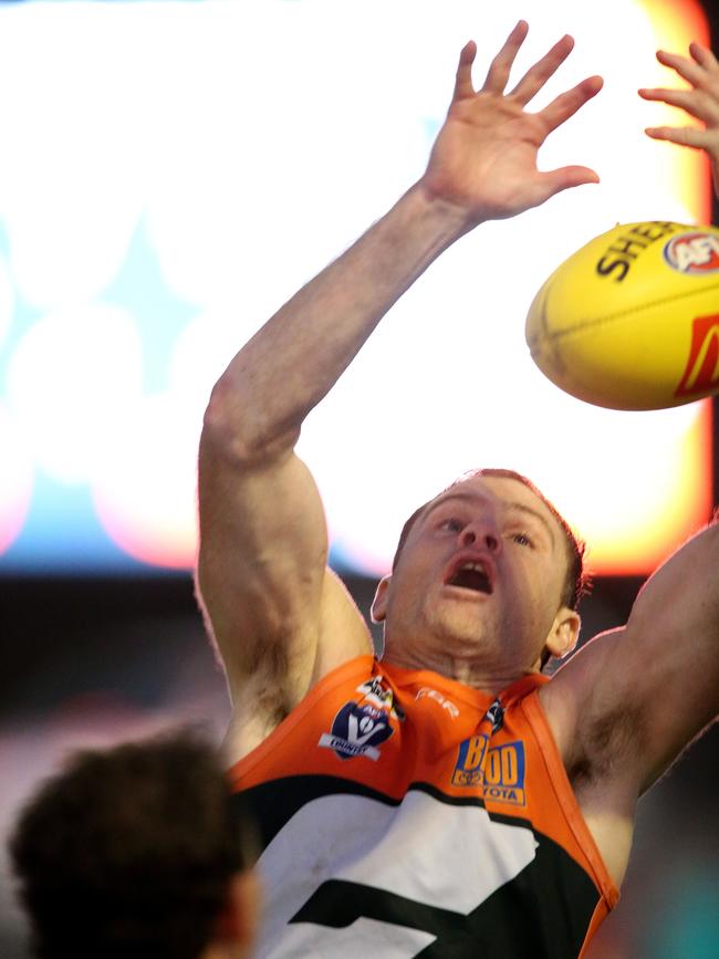 Heath Shaw goes for the grab under lights at Geelong West Oval on Saturday. Picture: Mike Dugdale