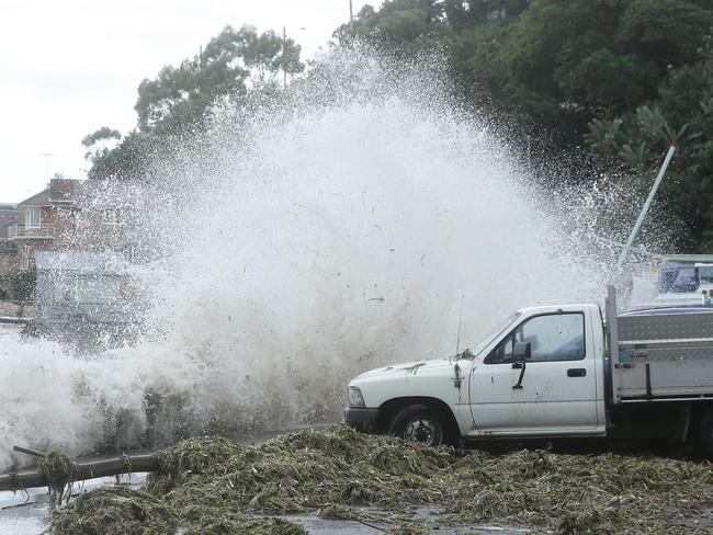 Waves pound the cars parked along the Pittwater waterfront during the storm surge.