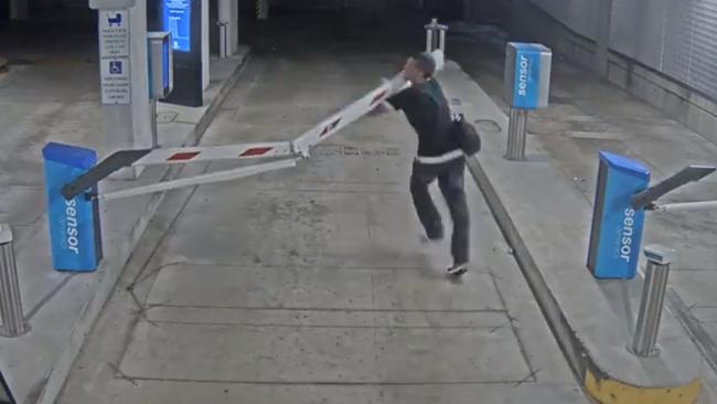 A man runs into a boom gate at the Darwin Waterfront Carpark