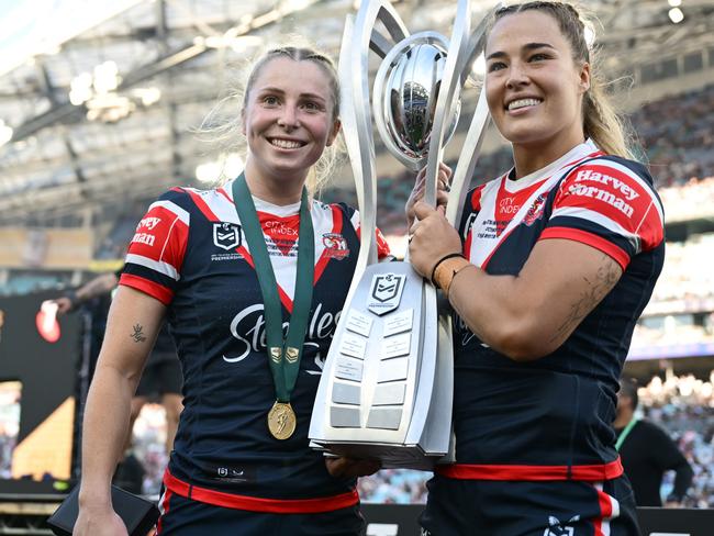 SYDNEY, AUSTRALIA - OCTOBER 06:  Tarryn Aiken and Isabelle Kelly of Roosters pose with the NRL Women's Premiership Trophy after winning the NRLW Grand Final match between Sydney Roosters and Cronulla Sharks at Accor Stadium on October 06, 2024, in Sydney, Australia. (Photo by Quinn Rooney/Getty Images)
