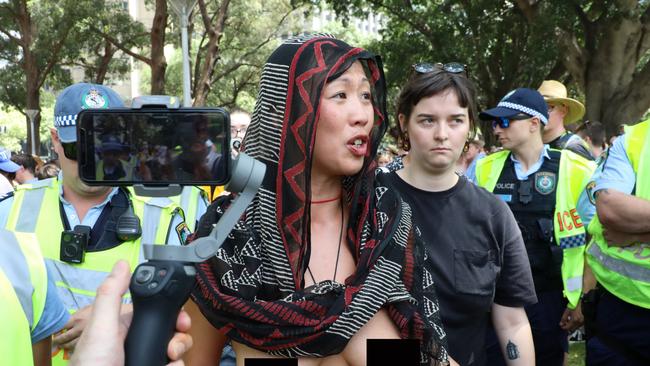 Police escort away a naked female protester an Invasion Day march in Sydney on January 26, 2020 Picture: Richard Milnes/Shutterstock