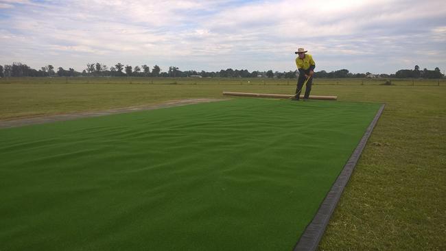 A photo of a synthetic turf field being laid.