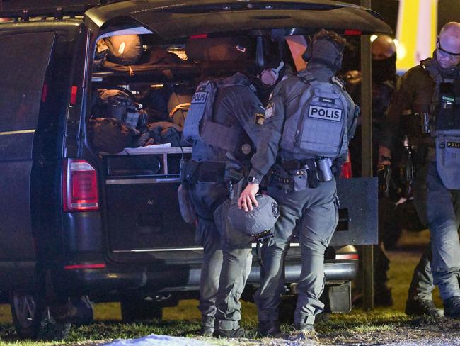 Members of the Police special forces leave the scene at the Risbergska School. Picture: AFP