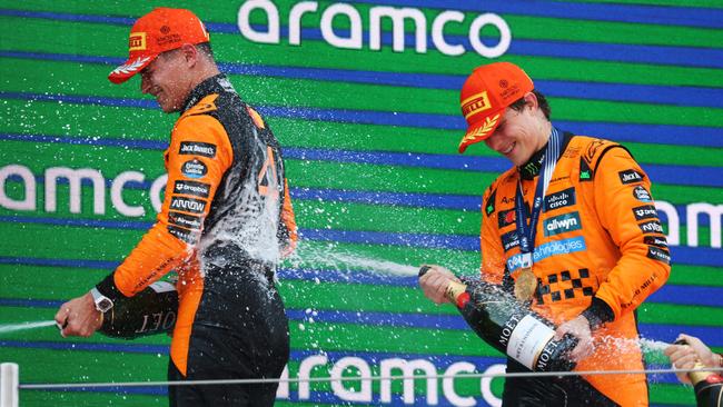 Race winner Oscar Piastri (right) sprays champagne at McLaren teammate Lando Norris on the podium after the Spanish Grand Prix. Picture: Getty