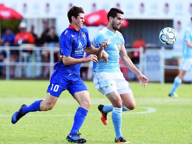 Brisbane City FC’s Nathan Bird (right) in action against NQ United's Jarrod Green