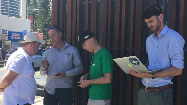 Council officials speak with Lime Director of Government Affairs Mitchell Price following the launch of the e-scooters on the esplanade at Surfers Paradise today. Photo: Talisa Eley