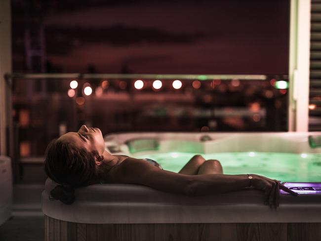 Young woman enjoying in her time she is spending relaxing in a jacuzzi.