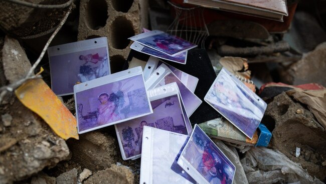 Family photos lie among the rubble of a destroyed building. Picture: Oliver Marsden/The Times