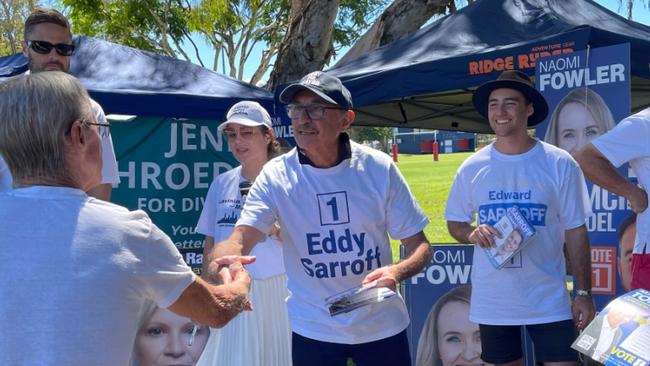 Eddy Sarroff and son Edward handing out how-to-vote leaflets at the Runaway Bay pre-poll in the 2024 Gold Coast local government election.