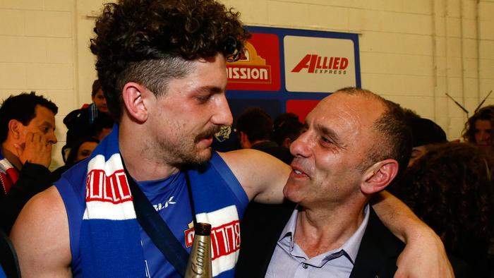 MELBOURNE, AUSTRALIA - OCTOBER 01: Tom Liberatore of the Bulldogs shares a beer with his dad Tony Liberatore during the 2016 Toyota AFL Grand Final match between the Sydney Swans and the Western Bulldogs at the Melbourne Cricket Ground on October 01, 2016 in Melbourne, Australia. (Photo by Adam Trafford/AFL Media/Getty Images)