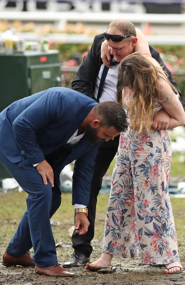 A racegoer loses her shoe in the mud. Picture: Scott Barbour/Getty Images