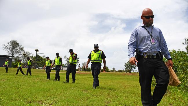 Northern Territory police officers perform a line search on Monday for items of interest related to an alleged sexual assault in Rapid Creek on Friday. Picture: Che Chorley