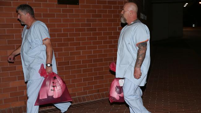 Two Nepean Hospital security guards attend Penrith Police station with their clothing in evidence bags following the shooting. Picture: Bill Hearne