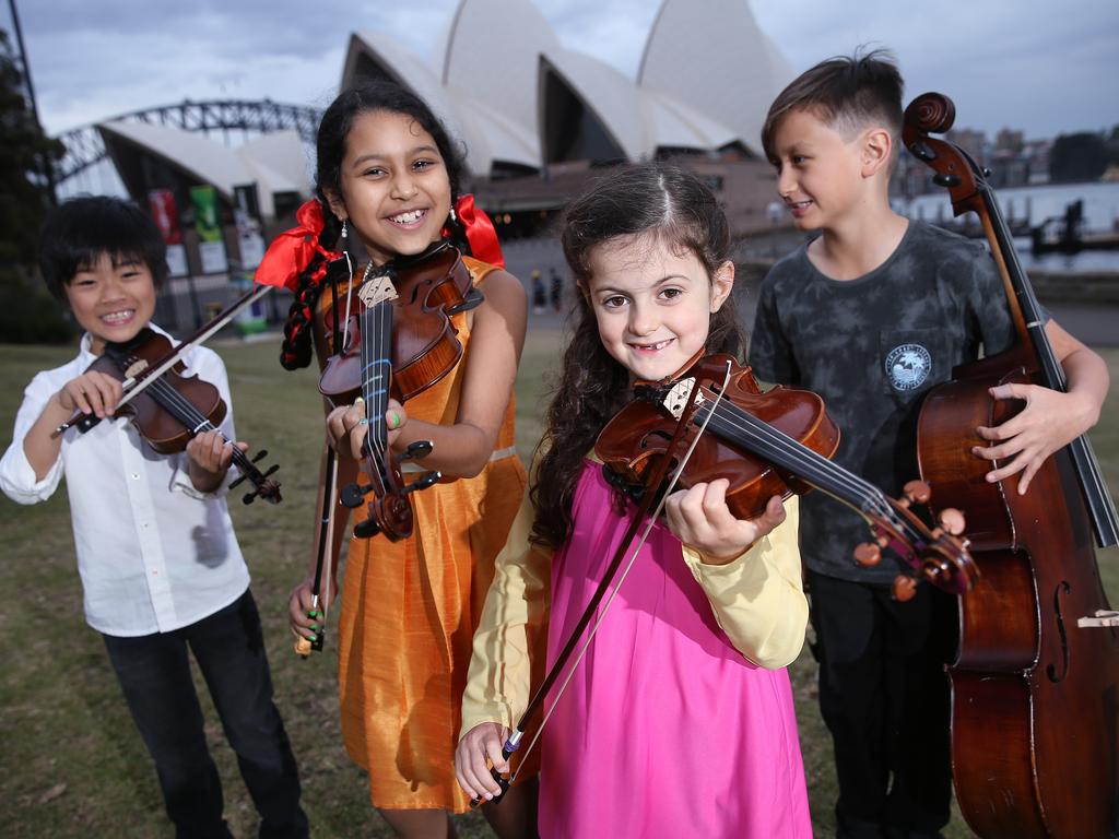 Sydney Youth Orchestras members pictured in front of the Sydney Opera House. From left: Sora Syrett-Lay, Nelum Purohit, Dara Minogue and William Oeser. Picture: Sam Ruttyn