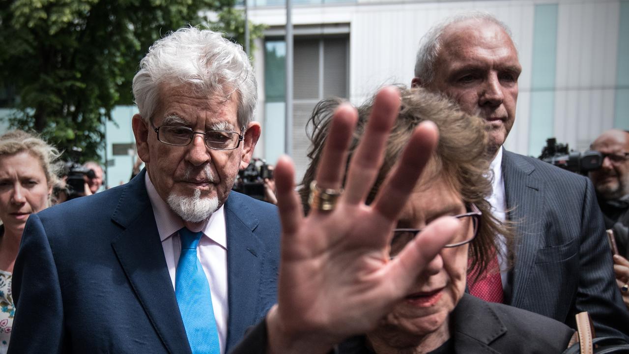 Rolf Harris leaves Southwark Crown Court as his niece Jenny Harris lifts her hand in front of cameras on May 30, 2017 in London. Picture: Getty