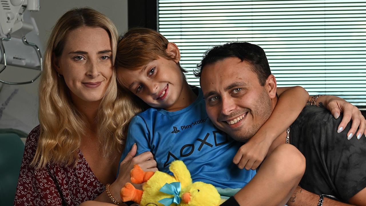 Jeziah Geisler, 8, his mum Jasmine Wilson and dad Amit Kilpatrick at Queensland Children's Hospital. Picture: Lyndon Mechielsen/Courier Mail