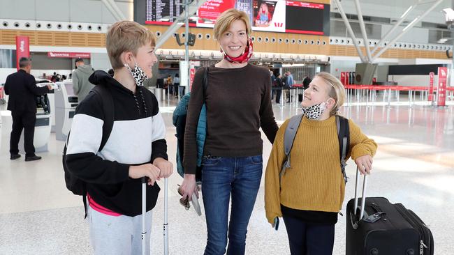 Melanie Street with her kids Alexander and Claudia at Sydney Airport, heading for Queensland. Picture: Tim Hunter.