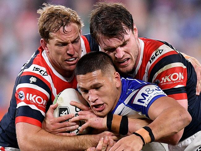 Dallin Watene-Zelezniak of the Bulldogs is tackled by Mitchell Aubusson (left) and Angus Crichton of the Roosters during the Round 5 NRL Match between the Canterbury Bulldogs and the Sydney Roosters at Bankwest Stadium in Sydney, Monday, June 15, 2020. (AAP Image/Dan Himbrechts) NO ARCHIVING, EDITORIAL USE ONLY