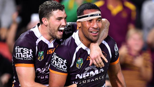 Tautau Moga celebrates a try with Broncos teammate Corey Oates.