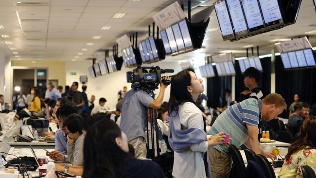 Journalists watch a telecast of Donald Trump's meeting with Singaporean Prime Minister Lee Hsien Loong. Picture: AP