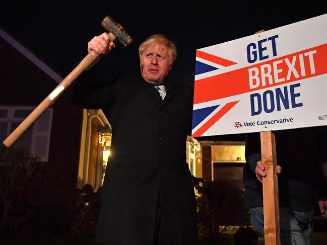 Britain's Prime Minister and Conservative party leader Boris Johnson poses after hammering a 