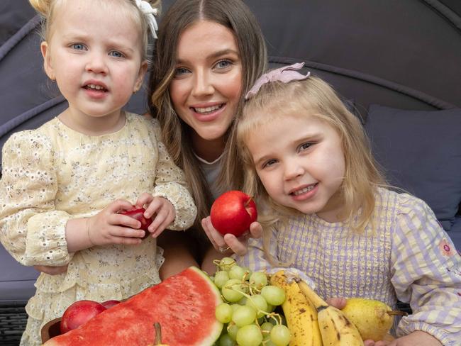 The reports calls for healthy check-outs at all supermarkets and to make healthy foods cheaper which mum Meg Marriott says is a good idea. She is with daughters Maisie and Meika. Picture: Tony Gough