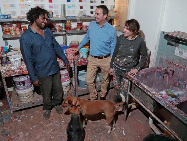 Steven Marshall flanked by artists Vincent Namatjira and Beth Conway at the Iwantja Arts centre in the Indulkana Community in the APY lands. Vincent is the great grandson of the legendary Albert Namatjira. Picture: Dylan Coker