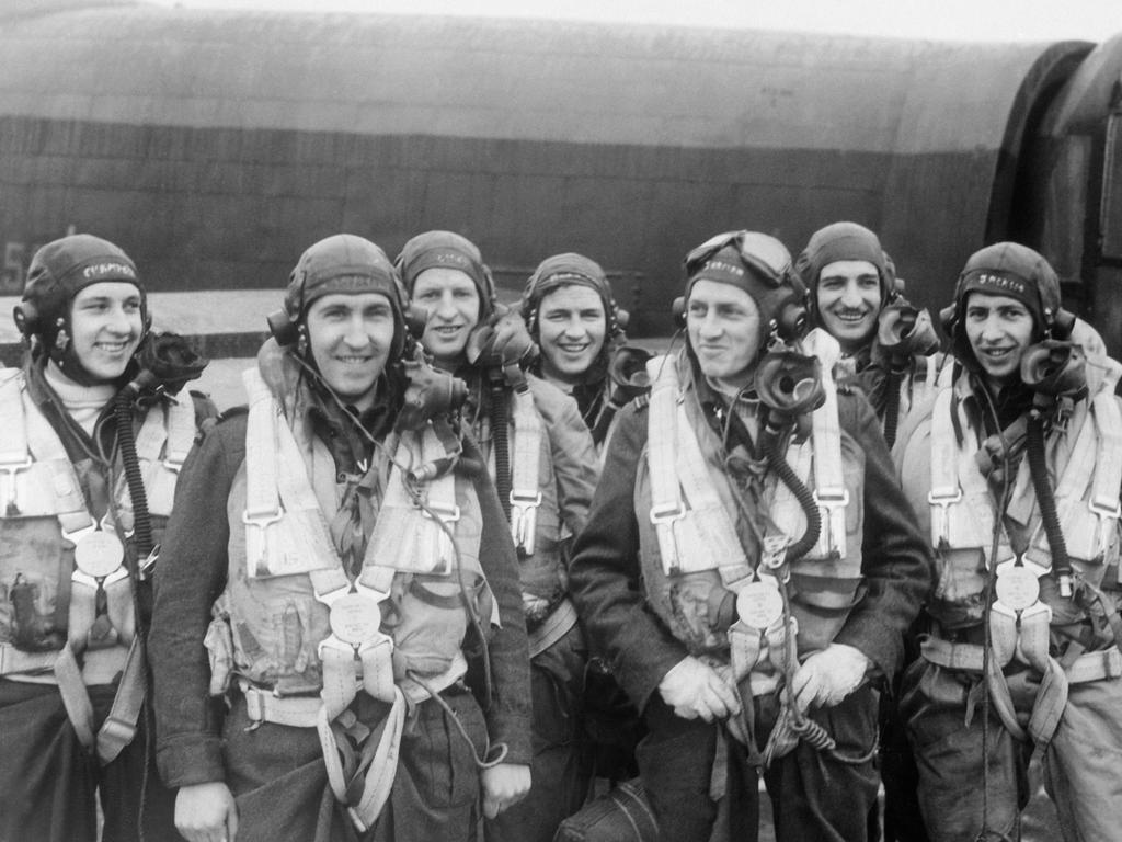 Binbrook, England. 1944-04-08. Members of the crew of a Lancaster of No. 460 squadron RAAF at the RAF station on their second tour of operations. Left to right: Sergeant D. G. Champkin, RAF; 408034 flying officer (fo) M. W. Carroll dfc, Ferntree Gully, Vic; 414807 pilot officer T. J. Lynch, Toowoomba, Qld; 404467 (fo) H. R. Harrison, Lismore, NSW; 404507 squadron leader E. G. D. Jarman dfc, Yeppoon, Qld, captain (third from right); 411227 (fo) R. L. Neal, Grenfell, NSW; 404503 (fo) F. G. Jackson dfc, Lismore, NSW.