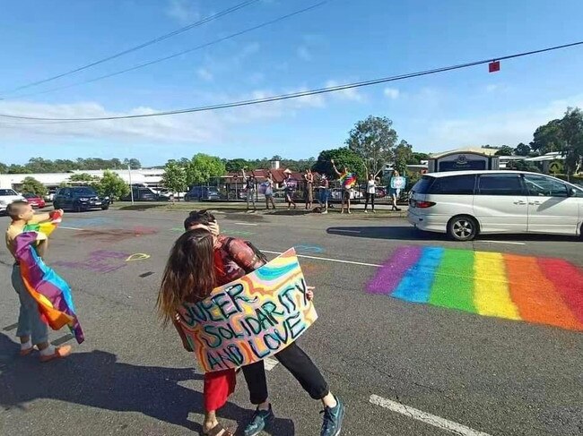 Protesters kiss outside Citipointe Christian College on Monday.