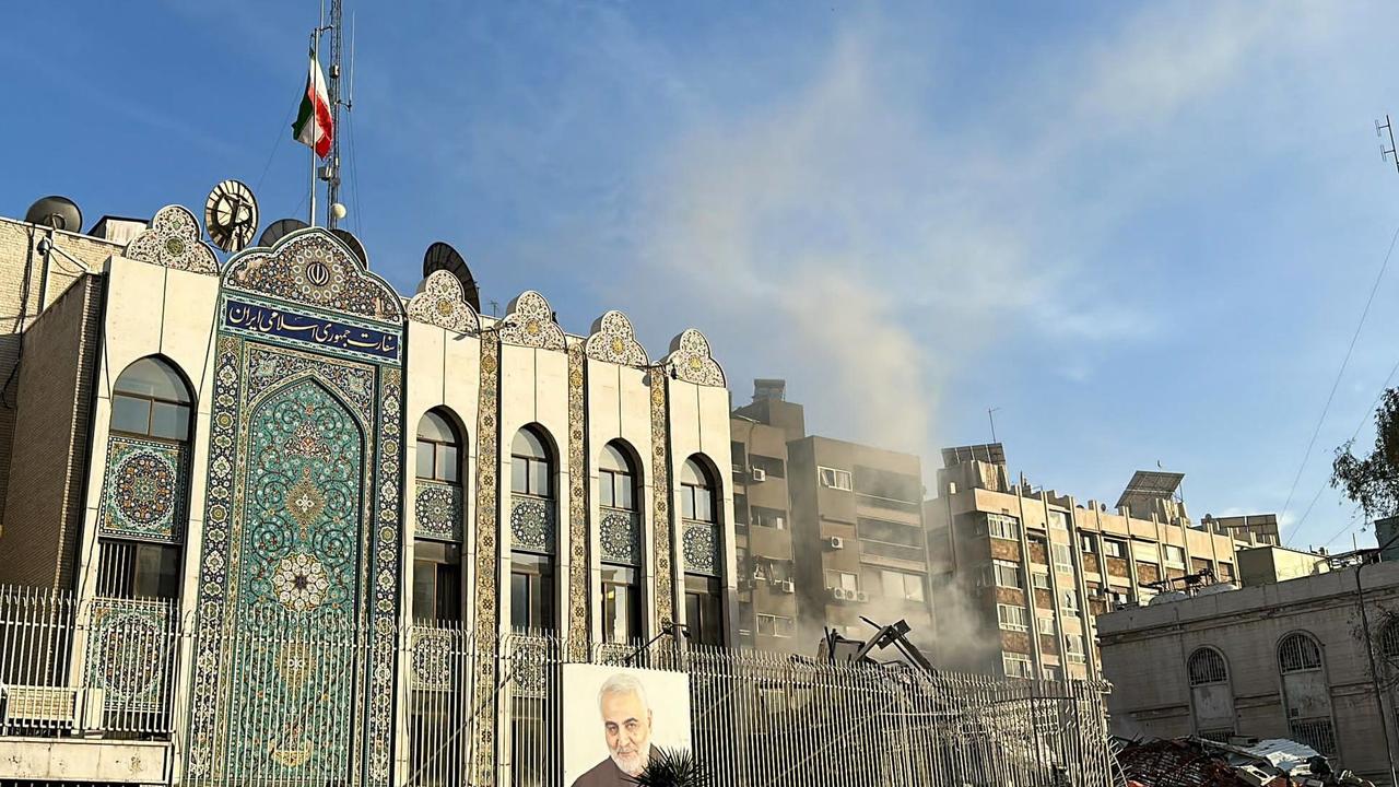 Emergency and security personnel gather at the site of strikes which hit a building adjacent to the Iranian embassy in Syria's capital Damascus, on April 1, 2024. Israeli strikes hit Syria's capital on April 1, state media reported, as a war monitor said six people were killed in a building adjacent to the Iranian embassy. (Photo by Maher AL MOUNES / AFP)