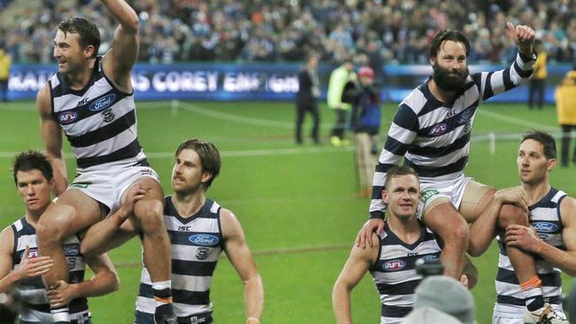 Jimmy Bartel and Corey Enright get chaired off. Picture: Michael Klein