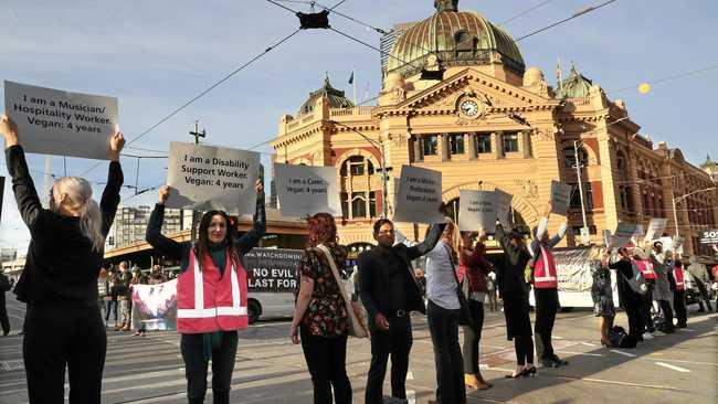 REALLY? Animal rights protesters block the intersections of Flinders and Swanston Street during early morning traffic in Melbourne, Monday, April 8, 2019. Picture: DAVID CROSLING