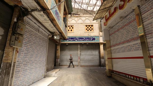 A lone Iranian man walks along an alley of a closed indoor markets in the capital Tehran. Picture: AFP