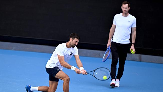 Murray watches on as Djokovic practices. (Photo by William WEST / AFP)