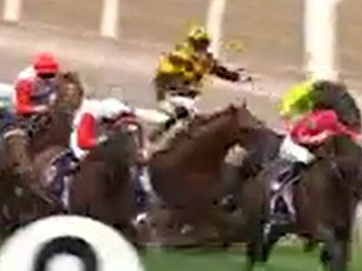 Maximillius (red and white) and Holymanz (yellow and black) were involved in a nasty fall at Flemington in the Group 1 Australian Guineas.