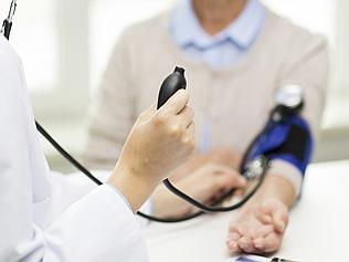 doctor with tonometer and senior woman at hospital