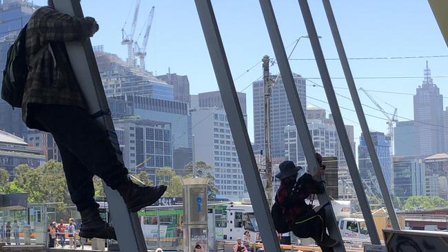 Protesters start to climb the building. Picture: Tessa Akerman