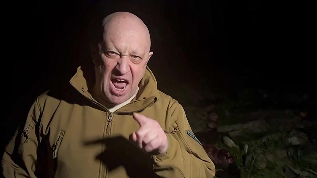 a Yevgeny Prigozhin addressing the Russian army's top brass standing in front of bodies he presented as fallen Wagner fighters at an undisclosed location.