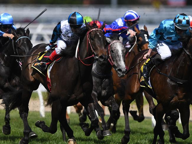 Jockey Craig Williams (second from left) rides Amphitrite to victory in the Thousand Guineas. Picture: AAP